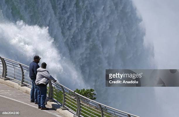 Visitors are seen on an observing tower to watch the Niagara Fall near Ontario River, in Canada, North America on May 08, 2017. Niagara Falls is one...