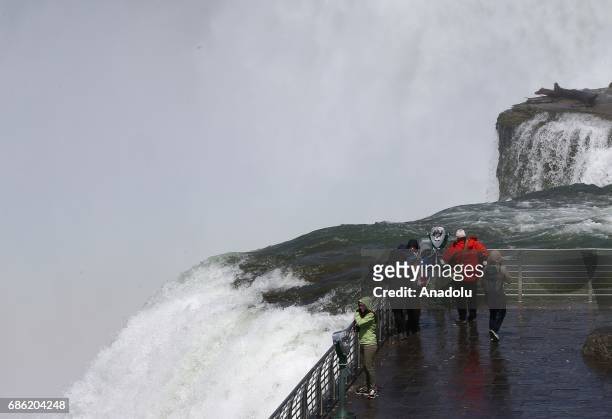 Visitors are seen on an observing tower to watch the Niagara Fall near Ontario River, in Canada, North America on May 08, 2017. Niagara Falls is one...