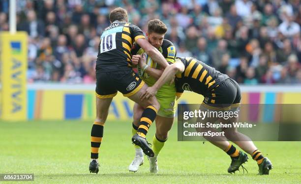 Leicester Tigers' Owen Williams is tackled by Wasps' Danny Cipriani and Tommy Taylor during the Aviva Premiership match between Wasps and Leicester...