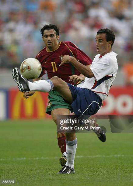 Sergio Conceicao of Portugal challenges Landon Donovan of USA during the first half of the Portugal v USA, Group D, World Cup Group Stage match...