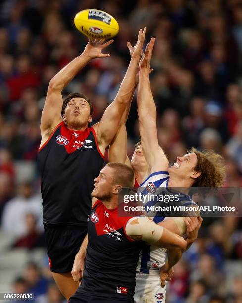 Michael Hibberd of the Demons, Tom McDonald of the Demons and Ben Brown of the Kangaroos compete for the ball during the 2017 AFL round 09 match...