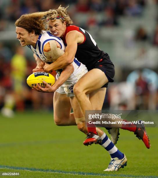 Ben Brown of the Kangaroos is tackled by Jayden Hunt of the Demons during the 2017 AFL round 09 match between the Melbourne Demons and the North...