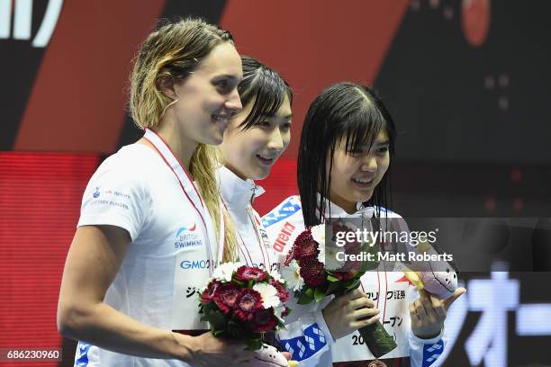 Alys Thomas of Great Britain, Rikako Ikee of Japan and Suzuka Hasegawa of Japan pose with their medals on the podium after the 100m Butterfly Final...