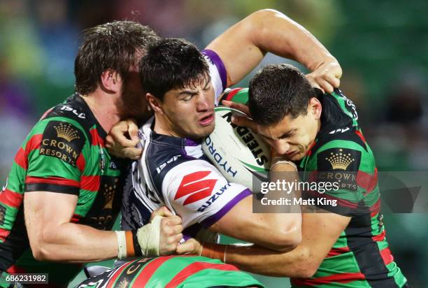 Jordan McLean of the Storm is tackled during the round 11 NRL match between the South Sydney Rabbitohs and the Melbourne Storm at nib Stadium on May...