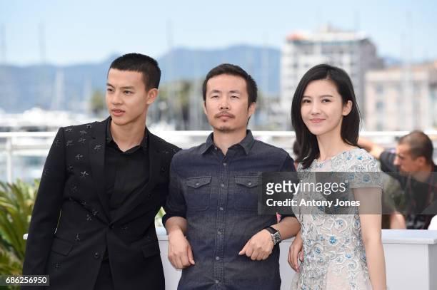 Actor Yin Fang, director Li Ruijun and actor Yang Zishan attend the "Walking Past The Future " photocall during the 70th annual Cannes Film Festival...