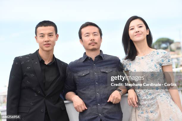 Actor Yin Fang, director Li Ruijun and actor Yang Zishan attend the "Walking Past The Future " photocall during the 70th annual Cannes Film Festival...