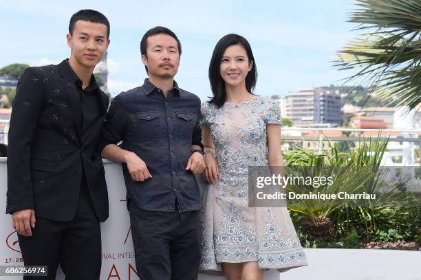 Actor Yin Fang, director Li Ruijun and actor Yang Zishan attend the "Walking Past The Future " photocall during the 70th annual Cannes Film Festival...