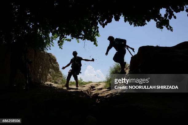 Afghan security force personnel patrol during an operation against Islamic State militants in the Chaparhar district of Nangarhar province on May 21,...