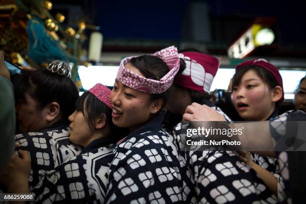 The residents of Asakusa band together to carry a 'mikoshi' while they chant together during the Sanja Festival in Asakusa, Tokyo on May 20, 2017....