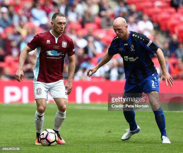 David Foley of South Shields looks to play the ball watched by Tim Lowe of Cleethorpes Town during The Buildbase FA Vase Final between South Shields...