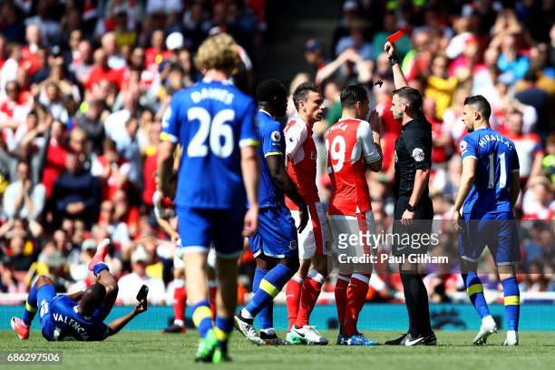 Laurent Koscielny of Arsenal is shown a red card by referee Michael Oliver during the Premier League match between Arsenal and Everton at Emirates...