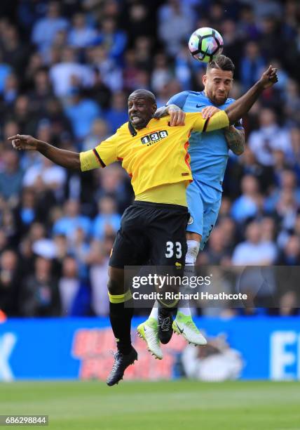 Stefano Okaka of Watford and Nicolas Otamendi of Manchester City clash during the Premier League match between Watford and Manchester City at...