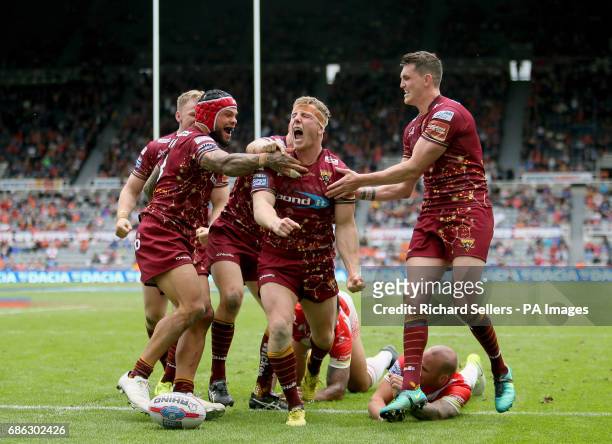 Huddersfield Giants players celebrate as Adam O'Brien scores a late try during day two of the Betfred Super League Magic Weekend at St James' Park,...