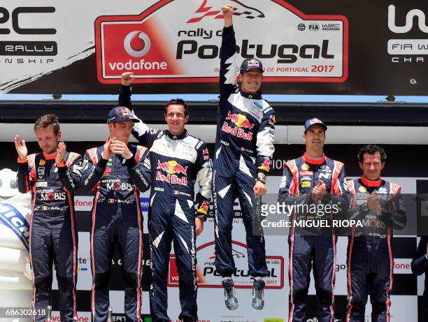 French driver Sebastien Ogier celebrates winning on the podium of the the SS19 stage beside Belgian co-driver Nicolas Gilsoul , Belgian driver...