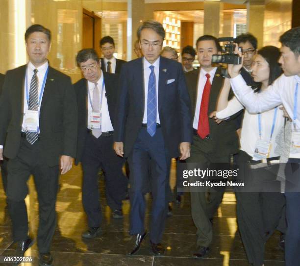 Nobuteru Ishihara , Japan's minister in charge of Trans-Pacific Partnership free trade negotiations, enters the host venue for the meetings between...