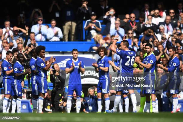 Chelsea players form a guard of honour as John Terry of Chelsea leaves the pitch for the final time following an injury during the Premier League...