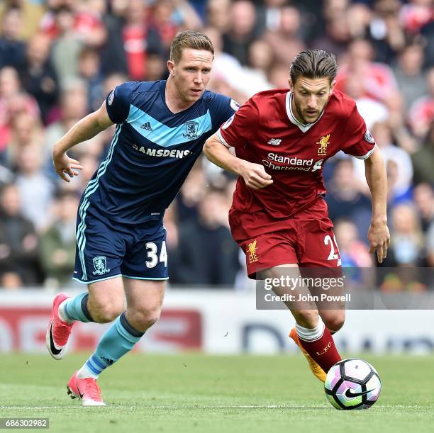 Adam Lallana of Liverpool competes with Adam Forshaw of Middlesbrough during the Premier League match between Liverpool F.C. And Middlesbrough F.C....