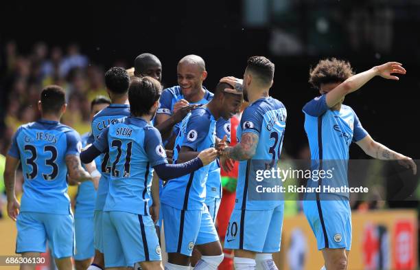 Fernandinho of Manchester City celebrates scoring his sides fourth goal with his Manchester City team mates during the Premier League match between...