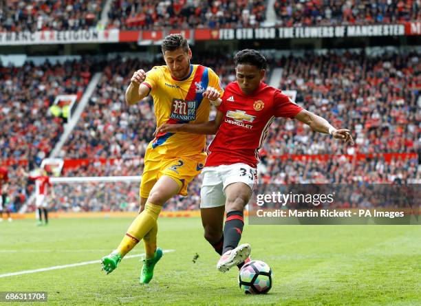 Crystal Palace's Joel Ward and Manchester United's Demetri Mitchell battle for the ball during the Premier League match at Old Trafford, Manchester.