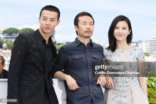 Actor Yin Fang, director Li Ruijun and actor Yang Zishan attend the "Walking Past The Future " photocall during the 70th annual Cannes Film Festival...