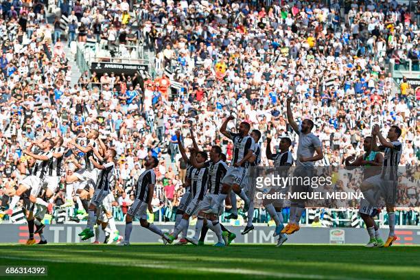 Juventus' players celebrate after winning the Italian Serie A football match Juventus vs Crotone and the "Scudetto" on May 21, 2017 at the Juventus...