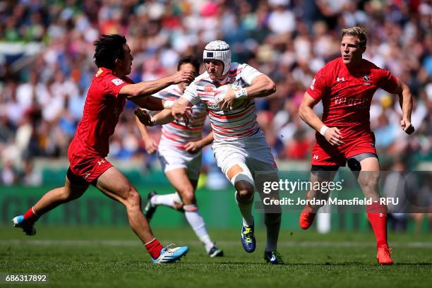 Phil Burgess of England is tackled by Nathan Nirayama of Canada during the semi-final match between England and Canada during day two of the HSBC...