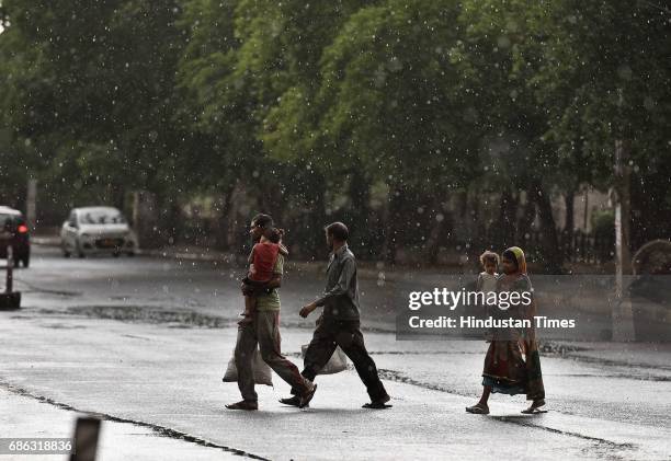 People caught in a sudden heavy rainfall and dust storm at MG Road, on May 21, 2017 in Gurugram, India. Heavy rainfall lashed Delhi/NCR evening...