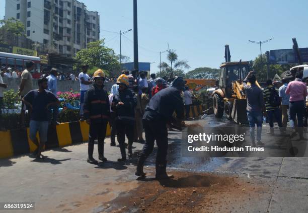 Fire personnel, Police personnel and bystander helping in rescuing passenger after a Private bus transporting people for reception from Malad to...