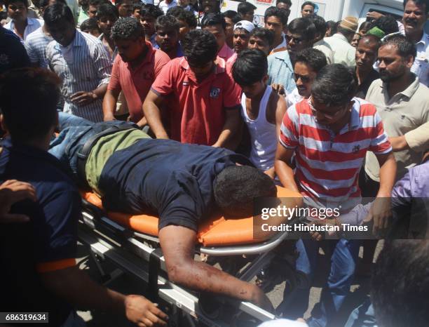 Fire personnel, Police personnel and bystander helping in rescuing passenger after a Private bus transporting people for reception from Malad to...