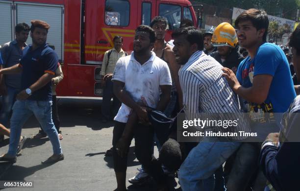 Fire personnel, Police personnel and bystander helping in rescuing passenger after a Private bus transporting people for reception from Malad to...