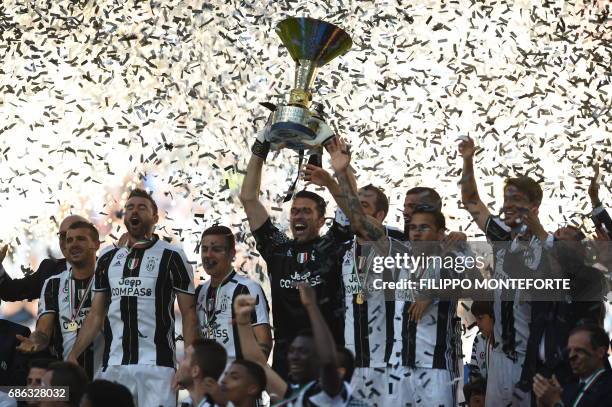 Juventus' players celebrate with the trophy after winning the Italian Serie A football match Juventus vs Crotone and the "Scudetto" at the Juventus...