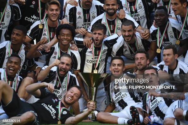 Juventus' players celebrate with the trophy after winning the Italian Serie A football match Juventus vs Crotone and the "Scudetto" at the Juventus...