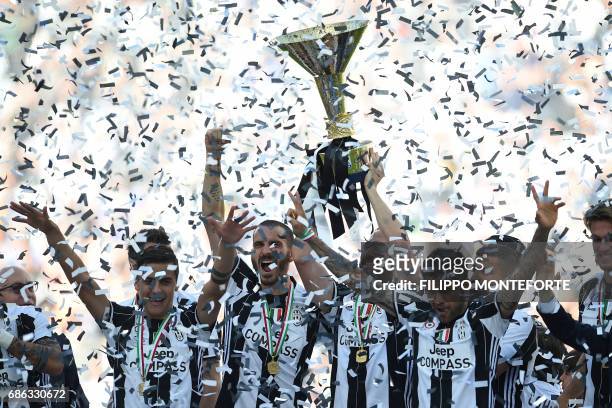 Juventus' players celebrate with the trophy after winning the Italian Serie A football match Juventus vs Crotone and the "Scudetto" at the Juventus...