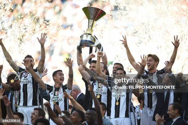 Juventus' players celebrate with the trophy after winning the Italian Serie A football match Juventus vs Crotone and the "Scudetto" at the Juventus...