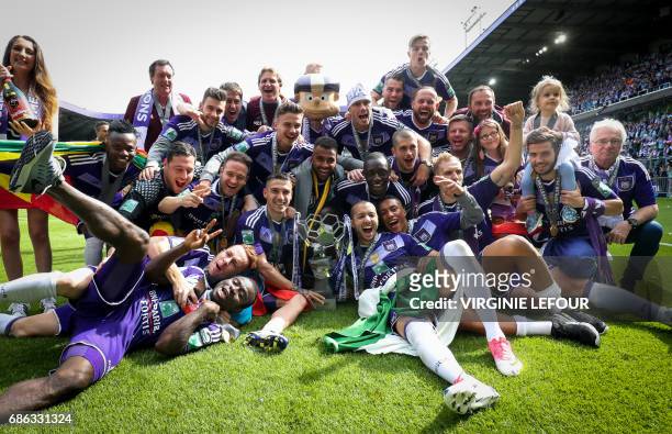 Anderlecht's players pose with the trophy as they celebrate winning their 34th Belgian championship title after the Jupiler Pro League match between...