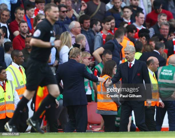 Claude Puel and Arsene Wenger shake hands during the Premier League match between Arsenal and Everton at Emirates Stadium on May 21, 2017 in London,...