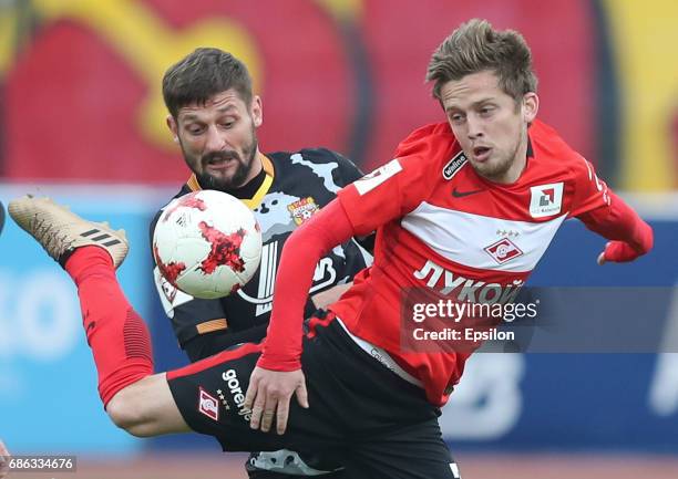 Igor Shevchenko of FC Arsenal Tula is challenged by Jano Ananidze of FC Spartak Moscow during the Russian Premier League match between FC Arsenal...