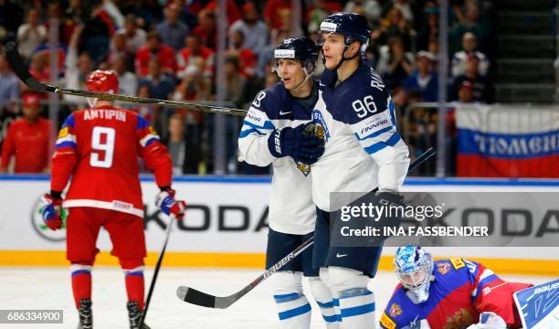 Finland's Veli-Matti Savinainen and Mikko Rantanen celebrate a goal against Russia during the IIHF Men's World Championship Ice Hockey bronze medal...