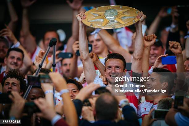 Captain Christian Gentner of Stuttgart lifts the Meisterschale as players and staffs celebrate the Second Bundesliga champions after the Second...