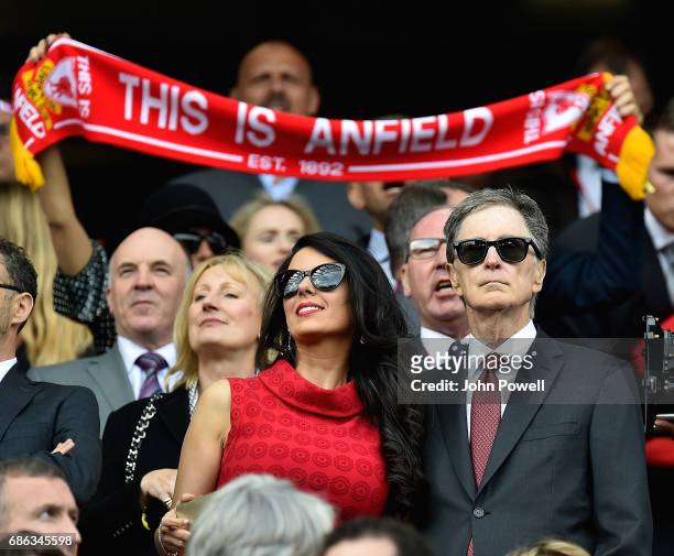 John W Henry principal owner of Liverpool and his wife Linda Pizzuti watch from the directors box before the Premier League match between Liverpool...