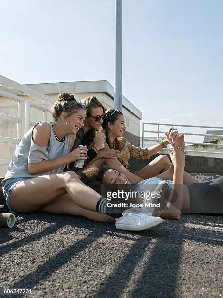 teenage girls having fun,  using smartphones - girls with short skirts photos et images de collection