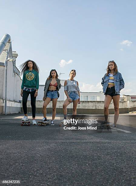 teenage girls with skateboards - girls in leggings stock-fotos und bilder