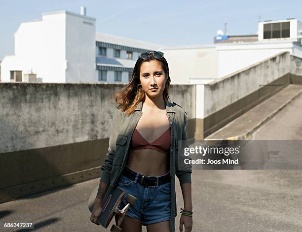 teenage girl with skateboard - people revolutionary front stock-fotos und bilder