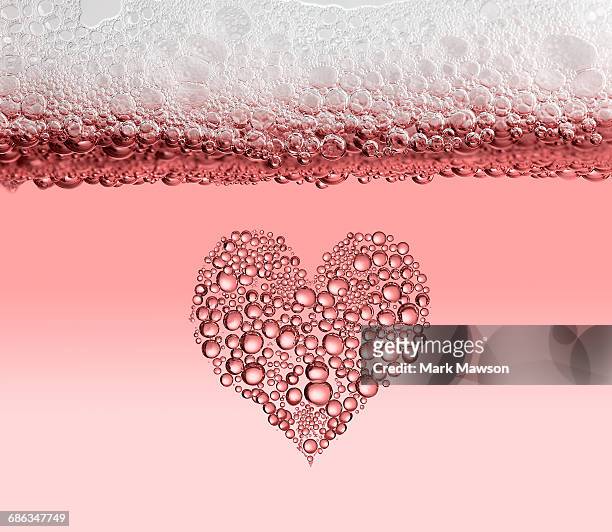 bubbles in drinks - pink champagne stock pictures, royalty-free photos & images