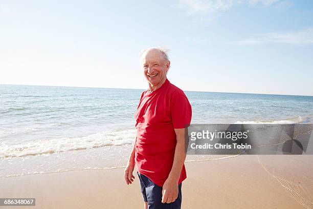old man standing on the beach - badehose stock-fotos und bilder