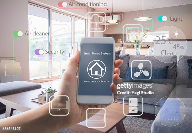 using a smart home device - home control - domotic bildbanksfoton och bilder