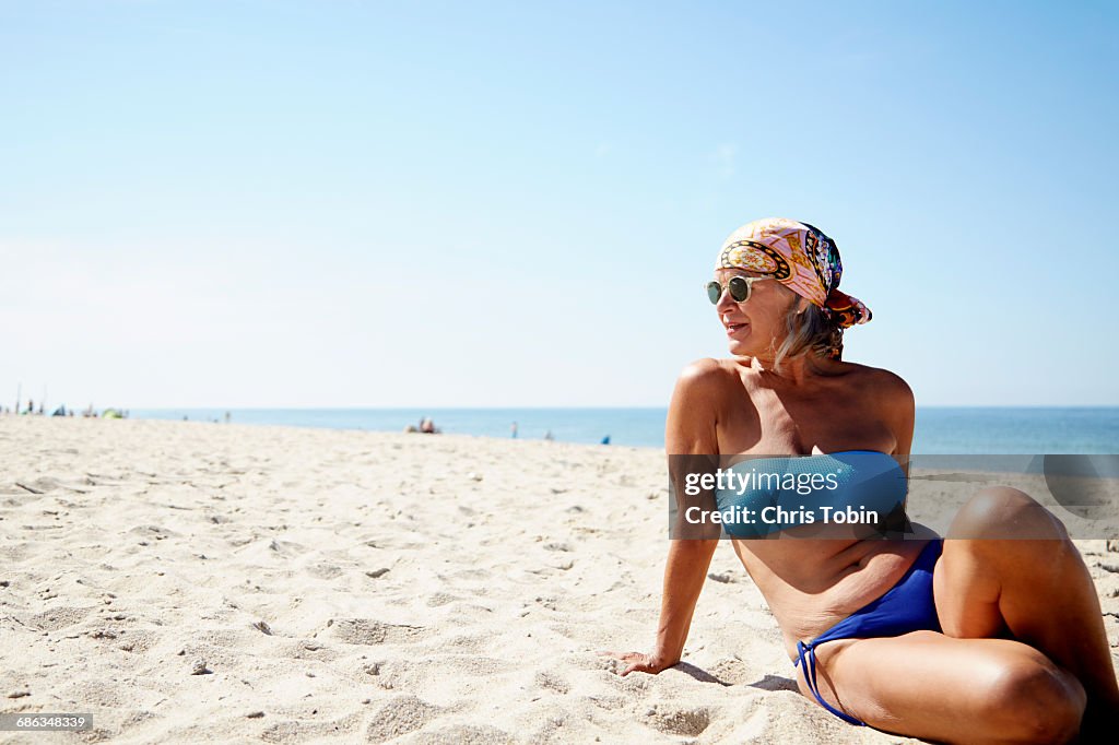 Older woman lounging on the beach