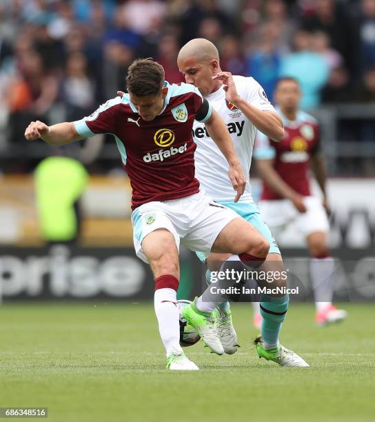 Sofiane Feghouli of West Ham United vies with Ashley Westwood of Burnley during the Premier League match between Burnley and West Ham United at Turf...