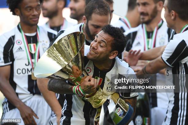 Juventus Defender from Brazil Dani Alves celebrates with the trophy after winning the Italian Serie A football match Juventus vs Crotone and the...