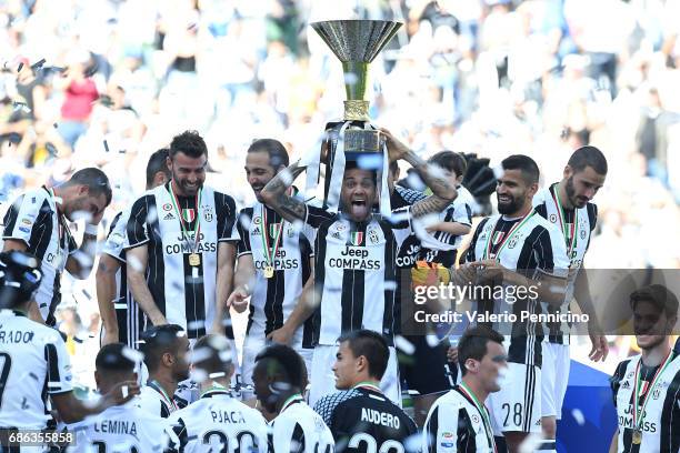 Daniel Alves of Juventus FC celebrates with the trophy after the beating FC Crotone 3-0 to win the Serie A Championships at the end of the Serie A...